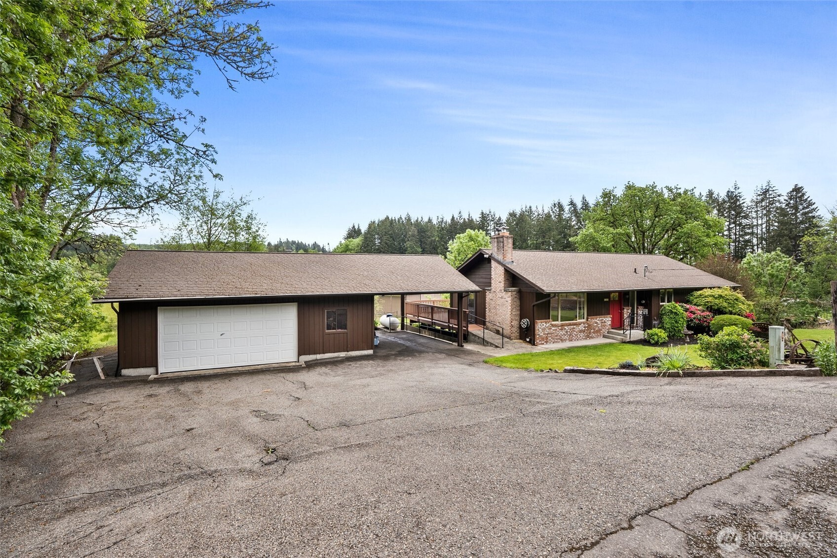154 Sanderson Road Chehalis, WA 98532 - Photo 4 of 27 a house with a garden and a trees