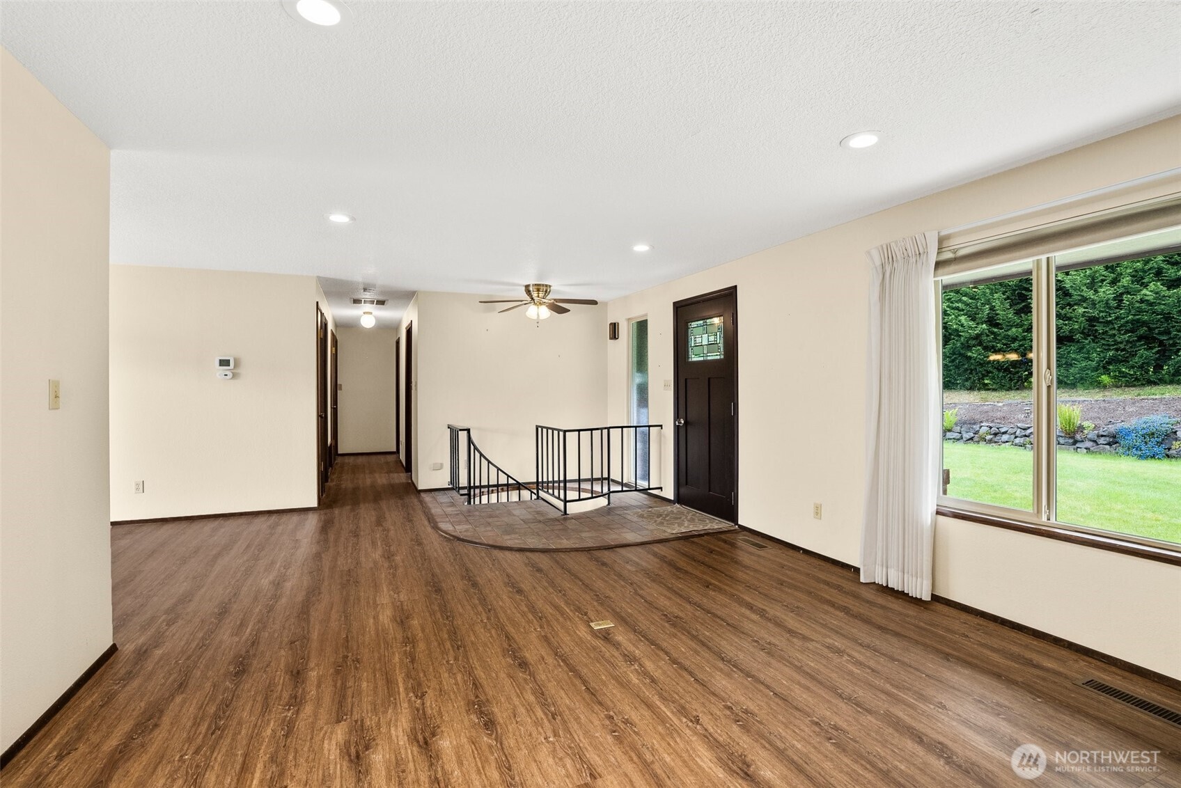 154 Sanderson Road Chehalis, WA 98532 - Photo 10 of 27 a view of an empty room with wooden floor and a window