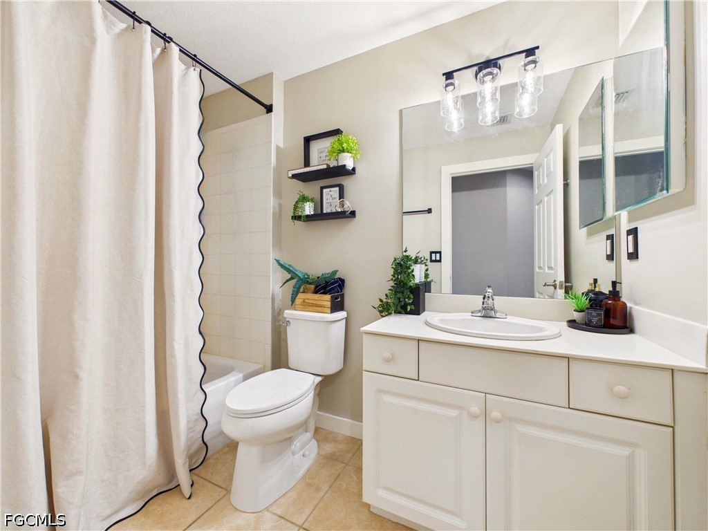 19694 Villa Rosa Loop Estero, FL 33967 - Photo 14 of 28 a bathroom with a sink a toilet and a mirror