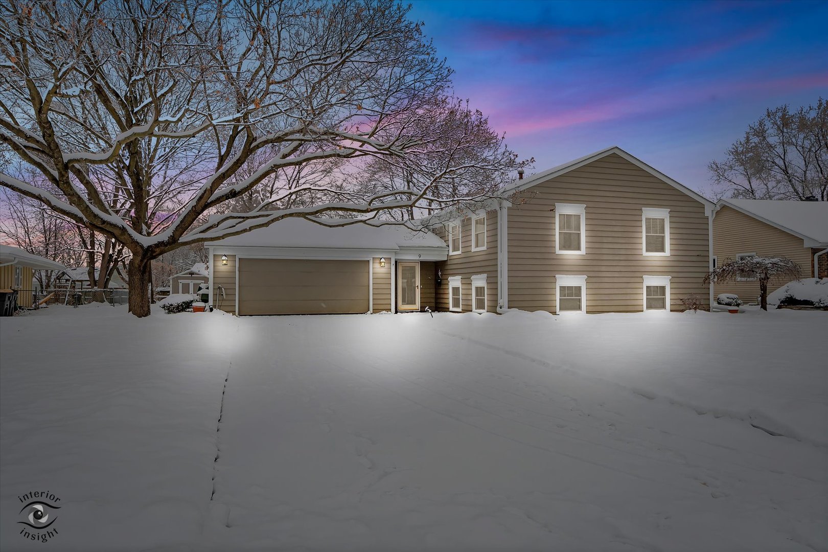a view of a house with a yard and garage