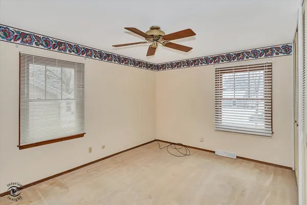 a view of a room with window and a ceiling fan