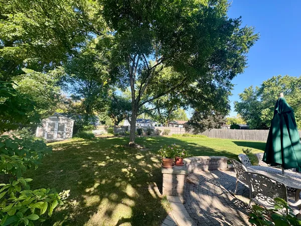 a view of yard with swimming pool and green space