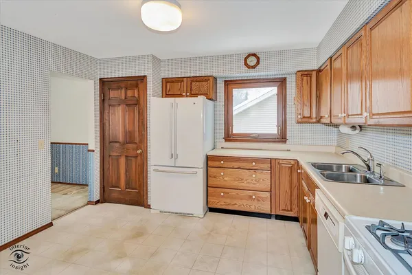 a kitchen with a refrigerator and a sink