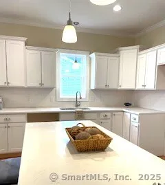 a kitchen with sink cabinets and wooden floor