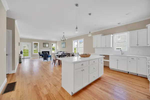 a kitchen with a table chairs microwave and cabinets