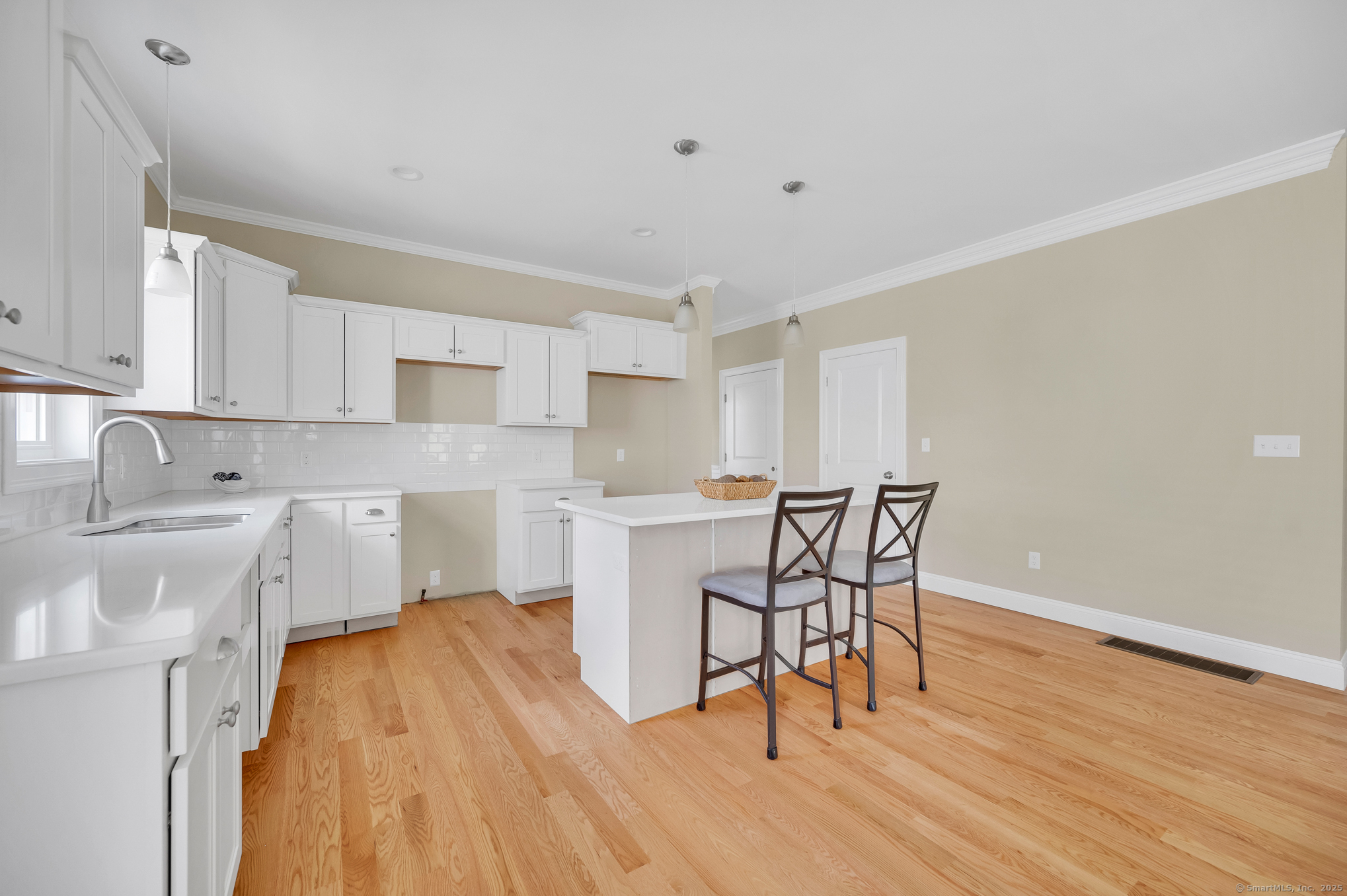 145 Webster Lane, Unit 241 Middletown, CT 06457 - Photo 7 of 22 a kitchen with a table chairs microwave and cabinets