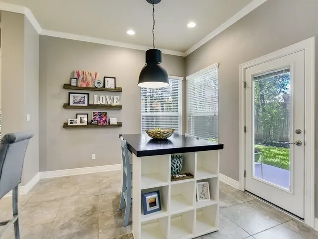 a very nice looking room with many windows and a chandelier