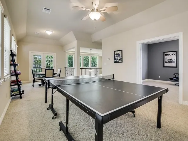 a room with table chairs and windows