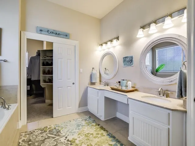 a room with sink and mirror