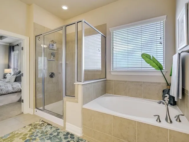 a bathroom with a bathtub and a shower