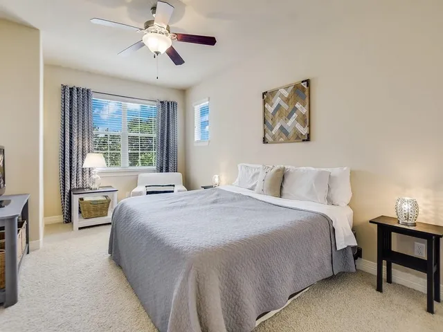 a spacious bedroom with a bed and a table