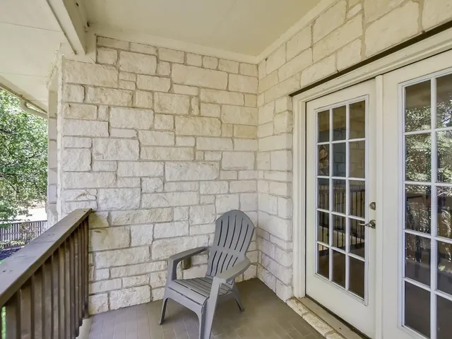 a balcony with table and chairs