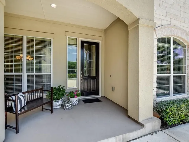 a view of a house with a chairs in a patio