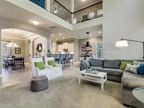 a living room with furniture and a chandelier