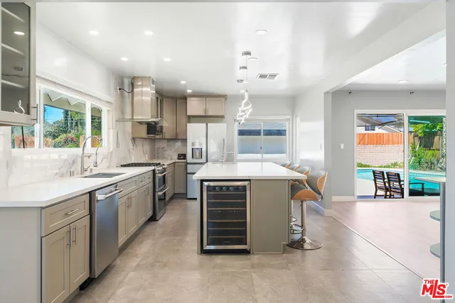 a kitchen with kitchen island white cabinets and white appliances