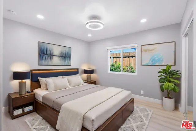 a bedroom with a large bed and a window