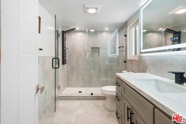 a bathroom with a sink toilet tub and shower