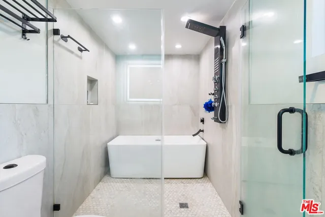 a bathroom with a shower a toilet and sink