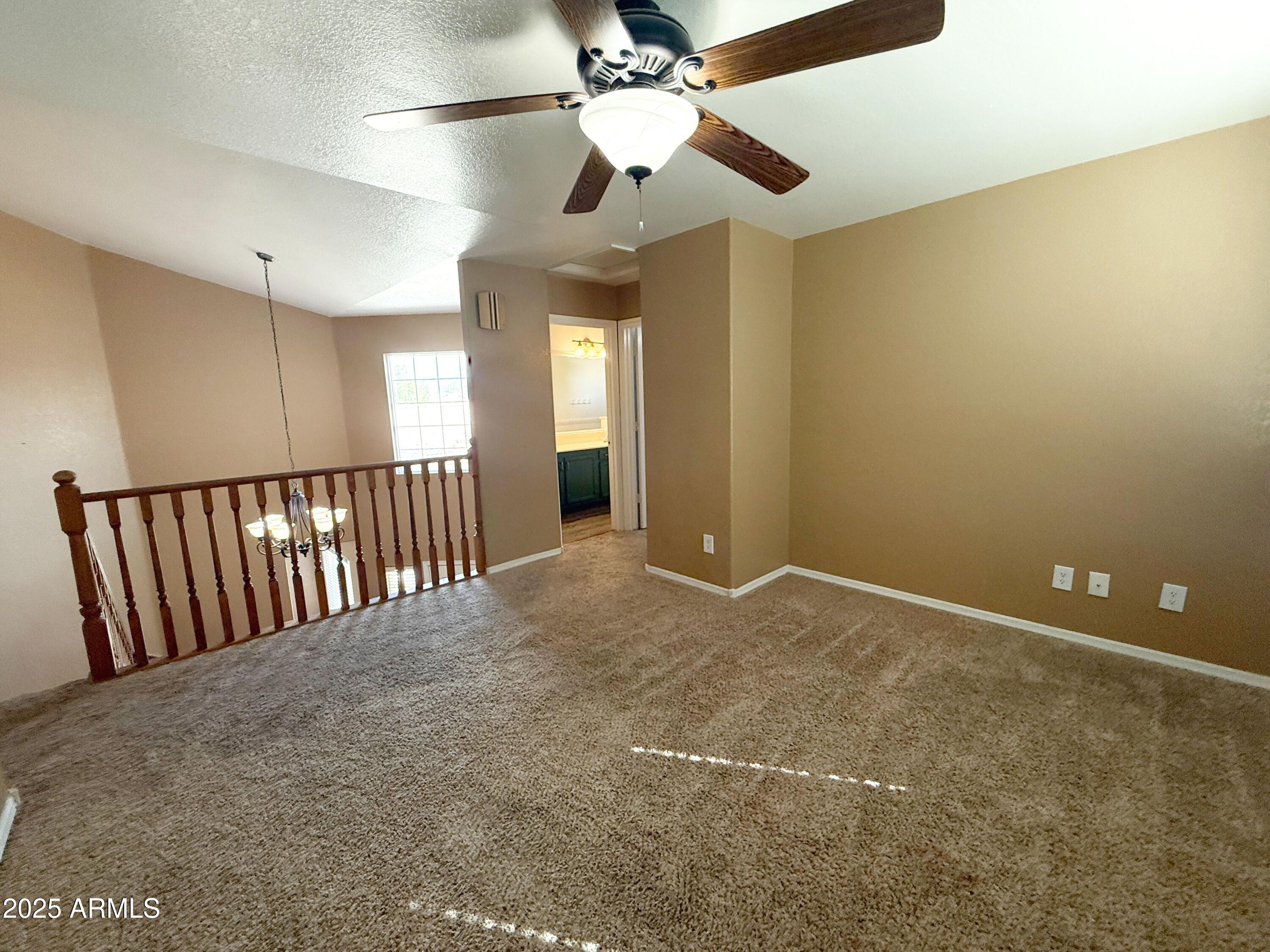 1670 East Gary Drive Chandler, AZ 85225 - Photo 13 of 34 a view of an empty room with a chandelier fan