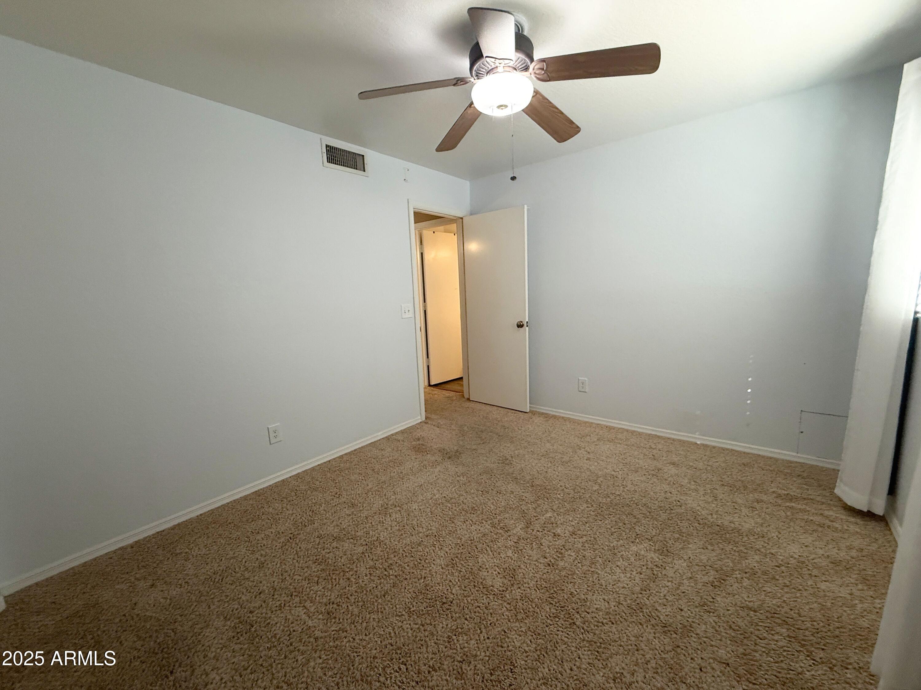 1670 East Gary Drive Chandler, AZ 85225 - Photo 15 of 34 an empty room with a fan & a window