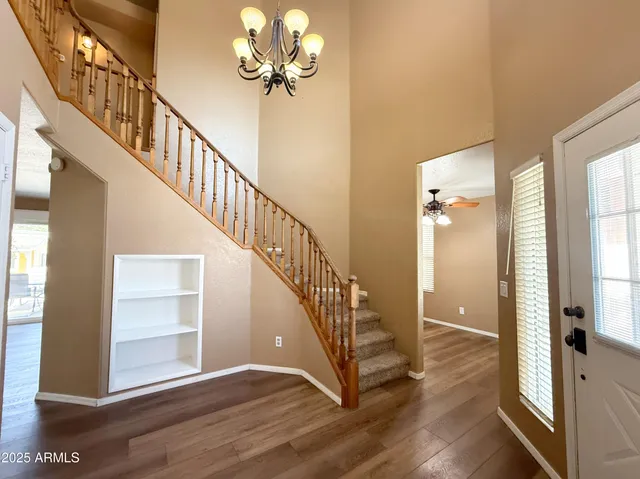 a view of entryway and hall with wooden floor