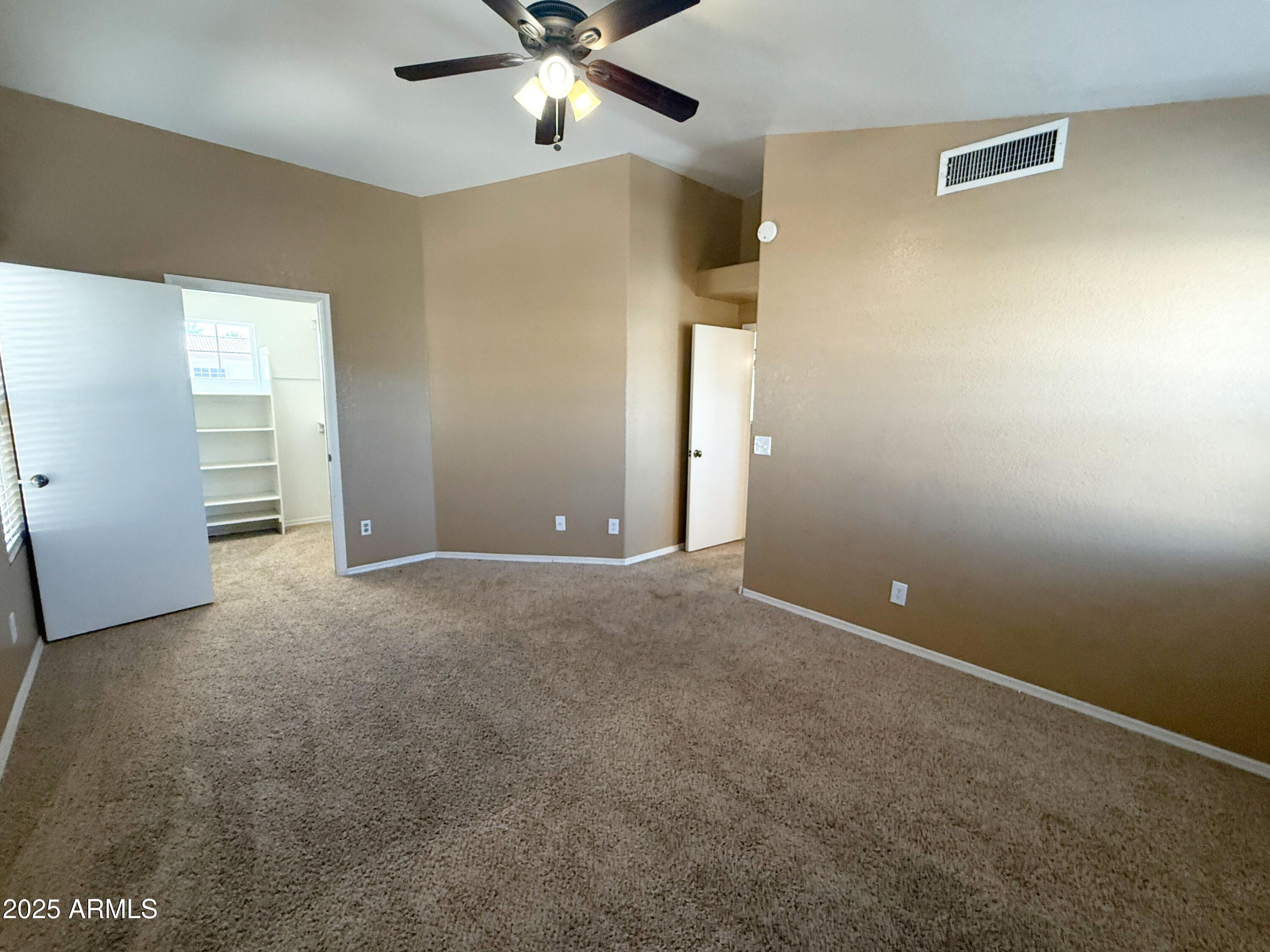 1670 East Gary Drive Chandler, AZ 85225 - Photo 21 of 34 a view of an empty room with a chandelier fan