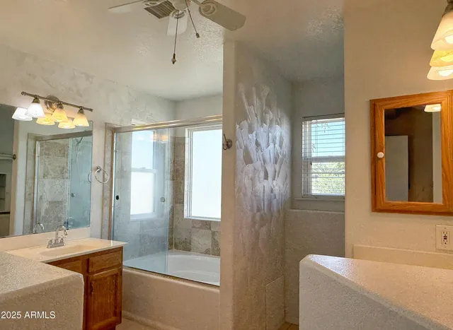 a bathroom with a tub sink shower and mirror
