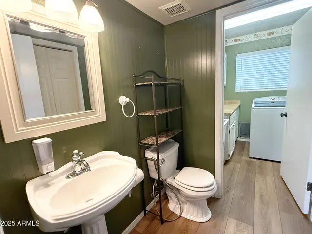 a bathroom with a toilet a sink and mirror