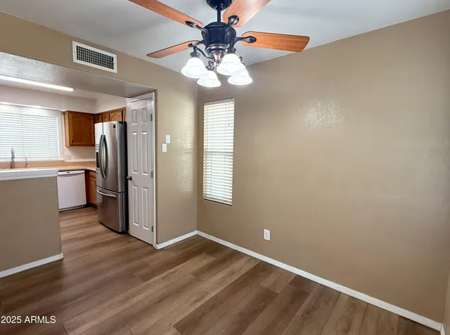 a view of a kitchen with a sink cabinets and wooden floor