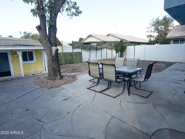 a view of a house with patio and a yard