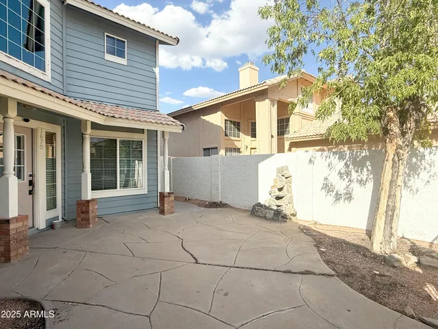 a backyard of a house with large trees and a tree