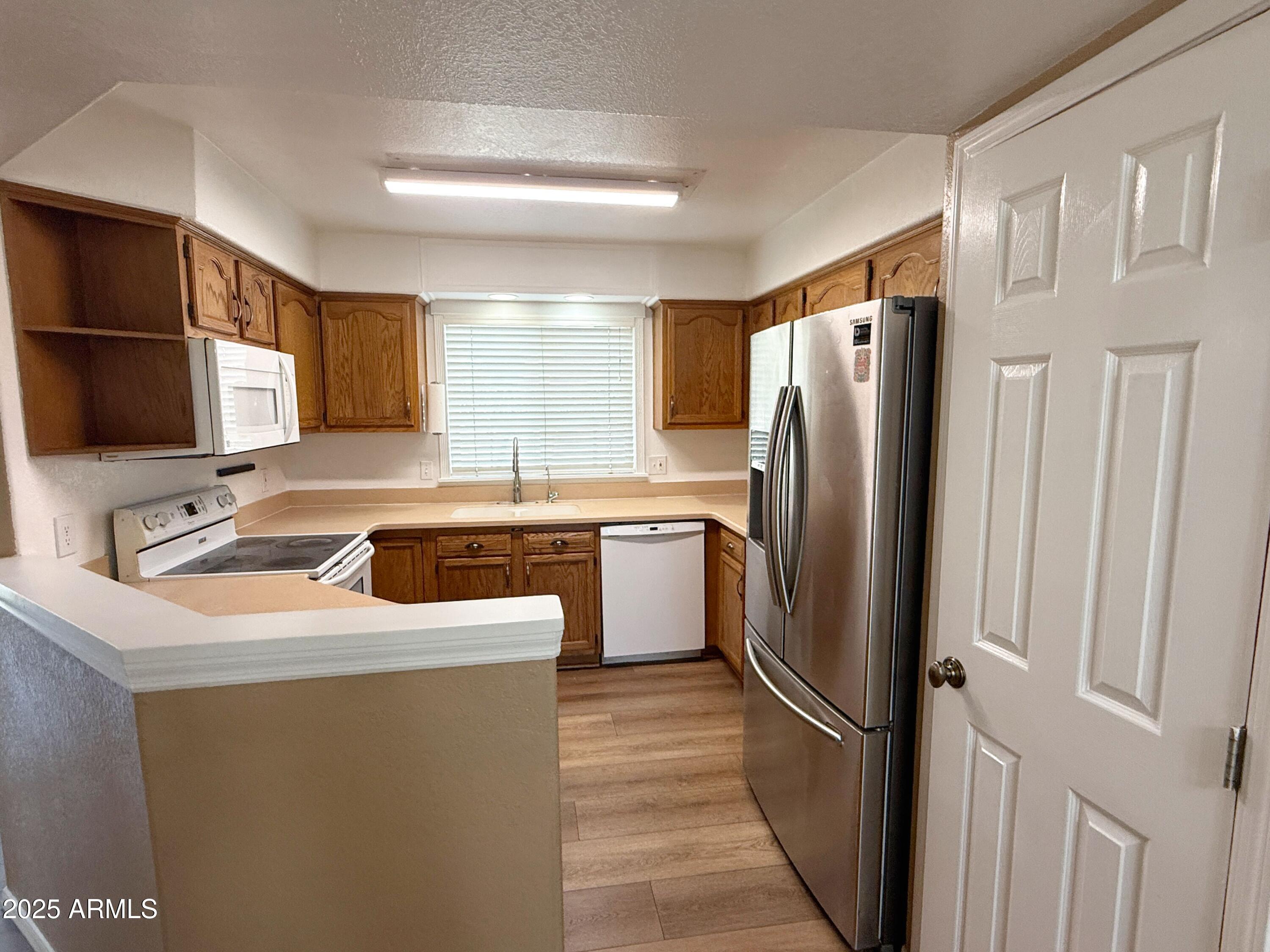 1670 East Gary Drive Chandler, AZ 85225 - Photo 5 of 34 a kitchen with a refrigerator sink and stove