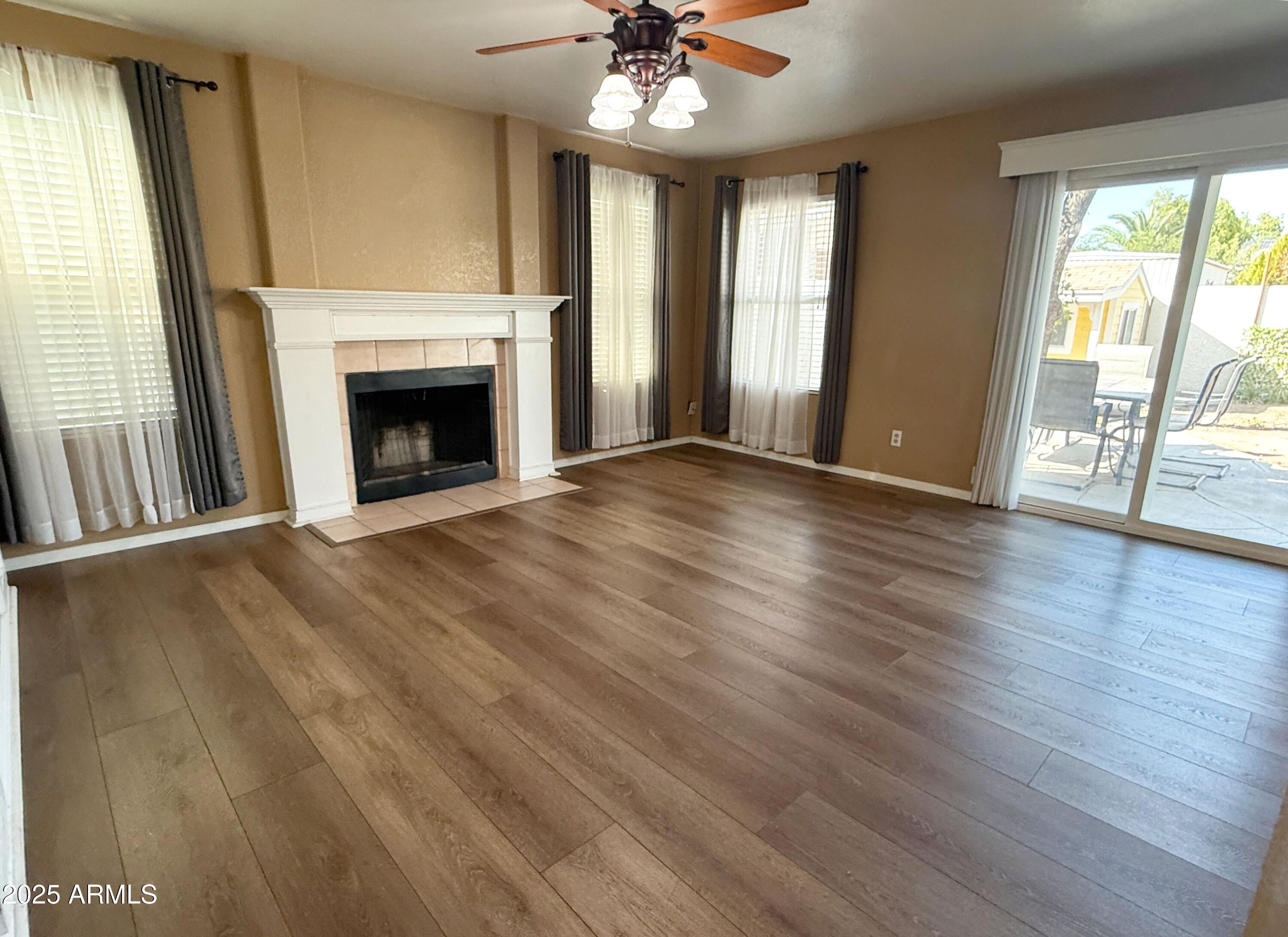 1670 East Gary Drive Chandler, AZ 85225 - Photo 7 of 34 a view of an empty room with wooden floor and a window