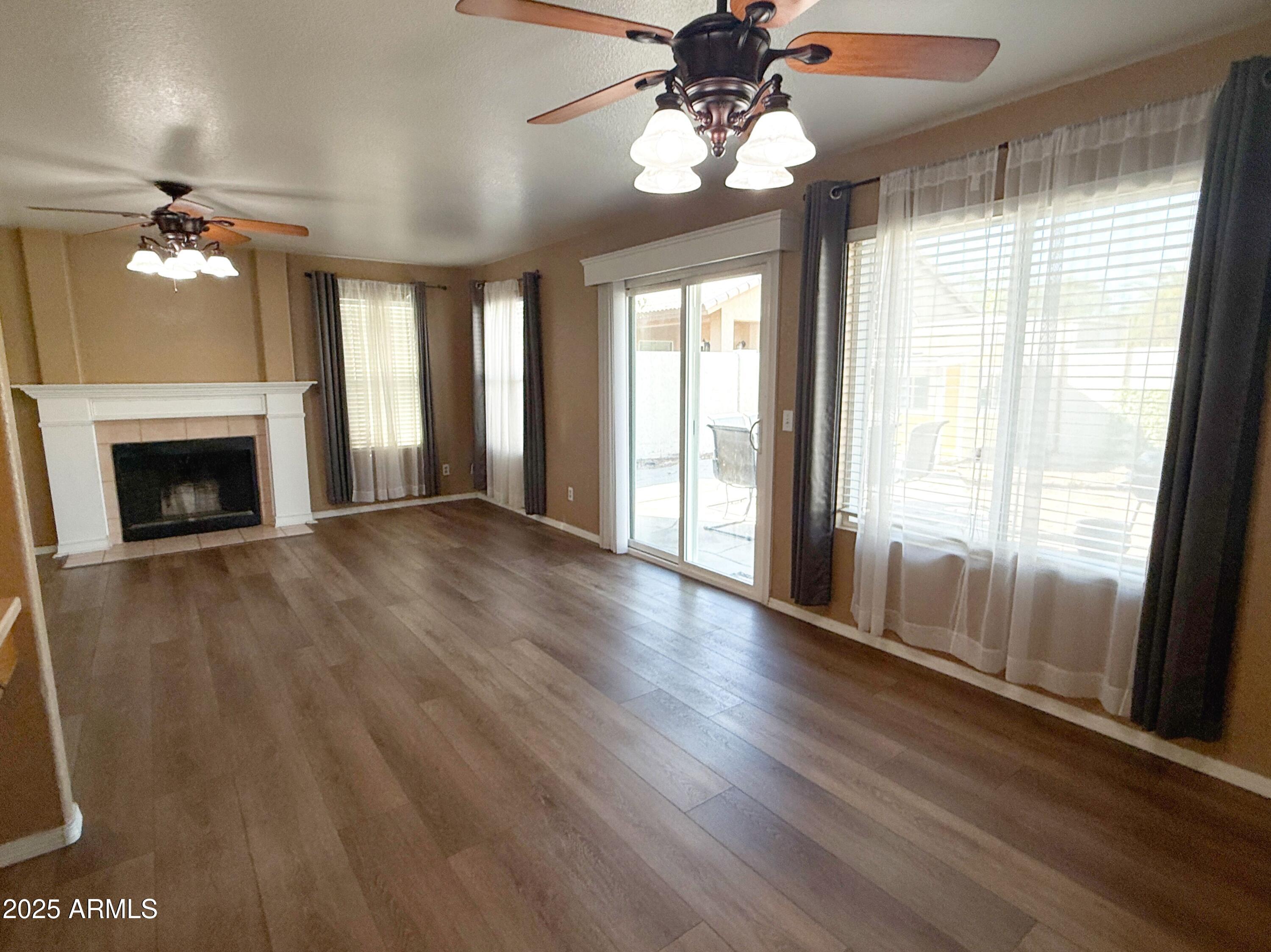 1670 East Gary Drive Chandler, AZ 85225 - Photo 9 of 34 a view of an empty room with wooden floor and a window