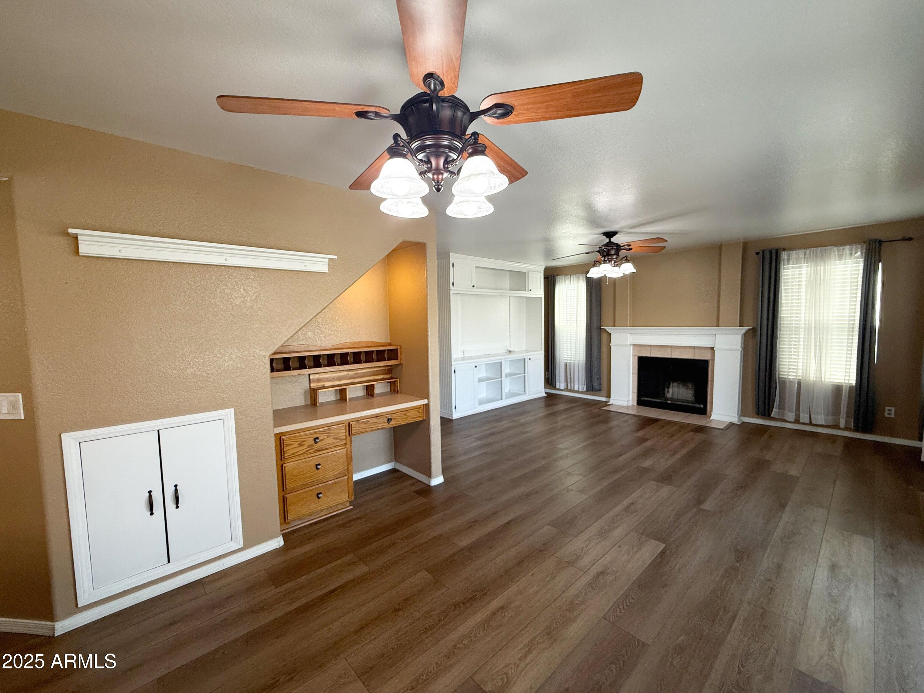 1670 East Gary Drive Chandler, AZ 85225 - Photo 10 of 34 a view of an empty room with a fireplace and wooden floor