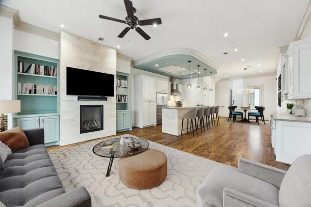 a living room with furniture a flat screen tv and a fireplace