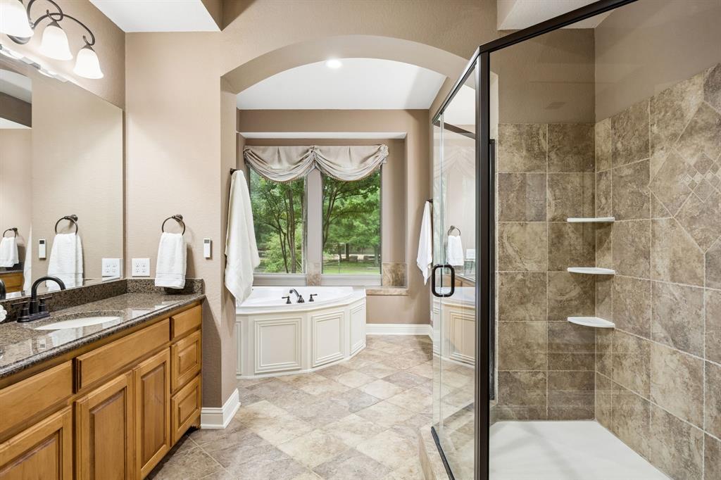 5802 Corinth Chapel Road Parker, TX 75002 - Photo 16 of 40 This bathroom is a dream! Oversized walk-in shower with updated surround, attachments & shelves as of 2024.