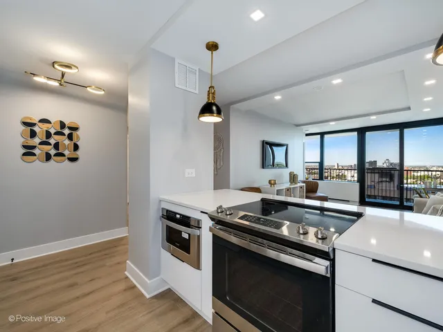 a kitchen that has a stove and a wooden floor