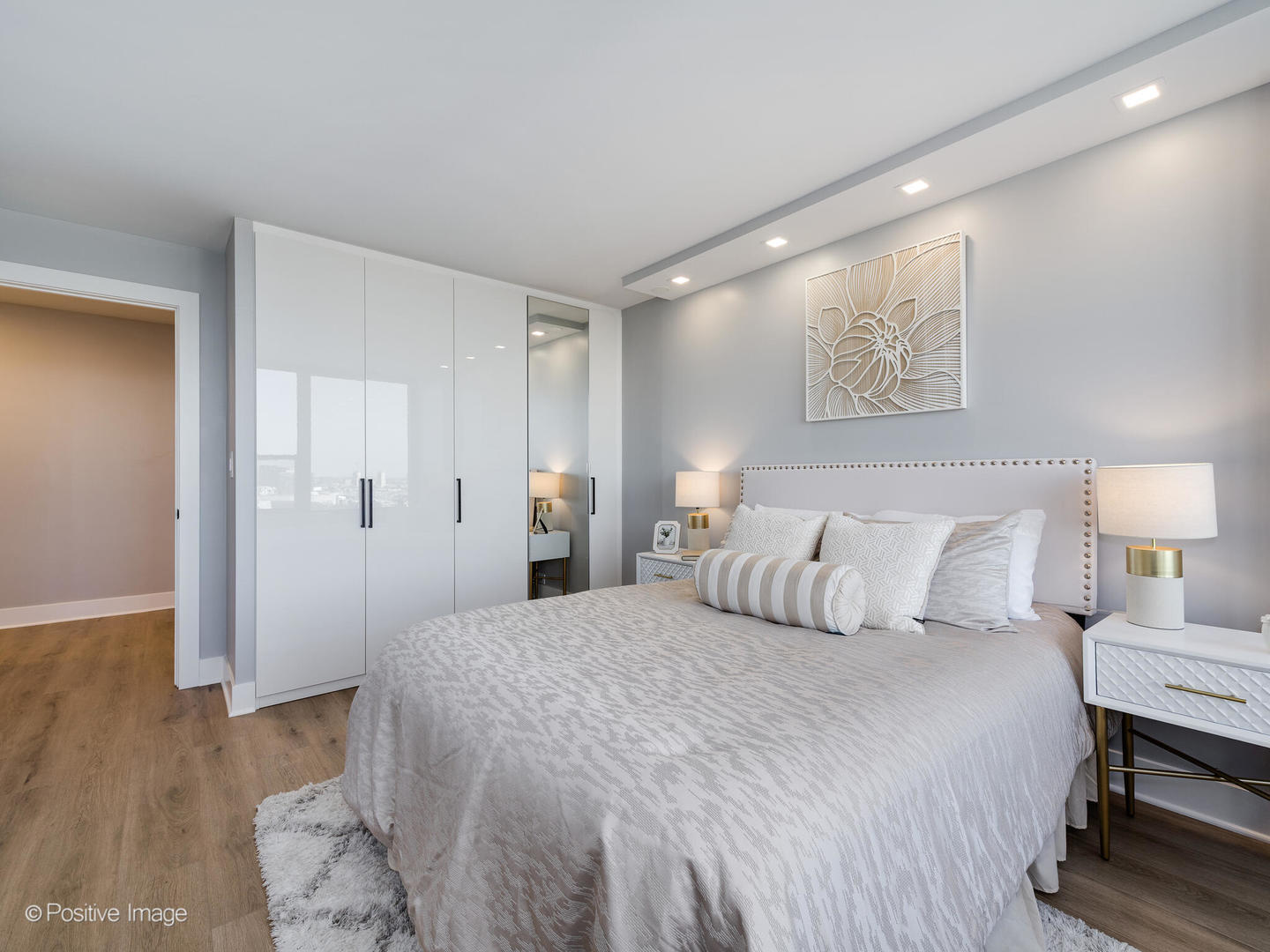 1560 North Sandburg Terrace, Unit 2403J Chicago, IL 60610 - Photo 16 of 45 a bedroom with a bed and wooden floor