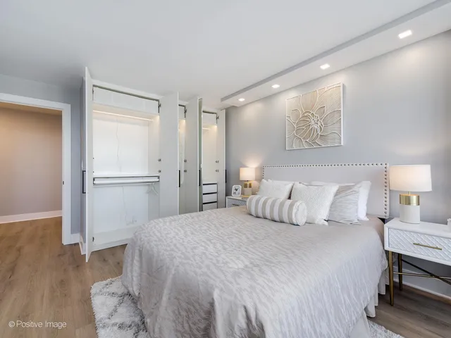 a bedroom with a bed and a refrigerator