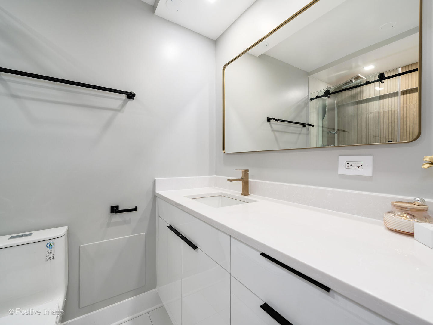 1560 North Sandburg Terrace, Unit 2403J Chicago, IL 60610 - Photo 18 of 45 a bathroom with a sink a toilet and mirror