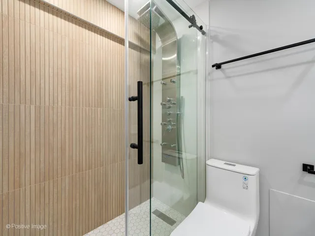 a bathroom with a shower and toilet