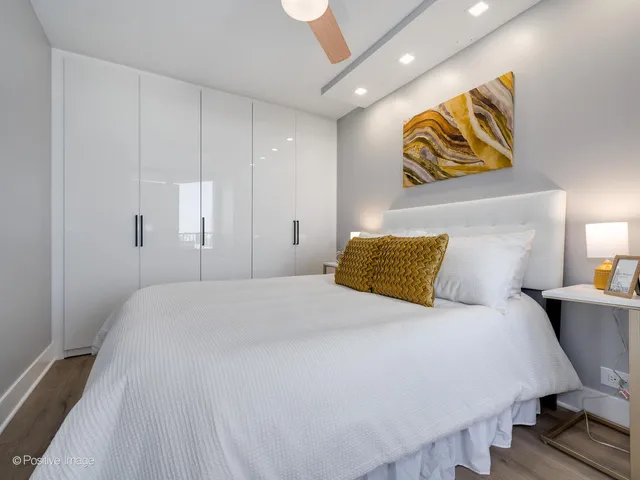 a bedroom with a bed and painting on the wall