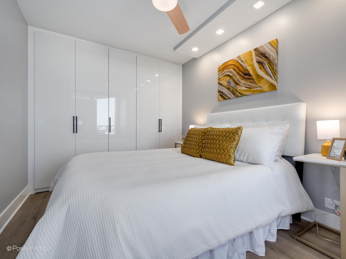 1560 North Sandburg Terrace, Unit 2403J Chicago, IL 60610 - Photo 20 of 45 a bedroom with a bed and painting on the wall