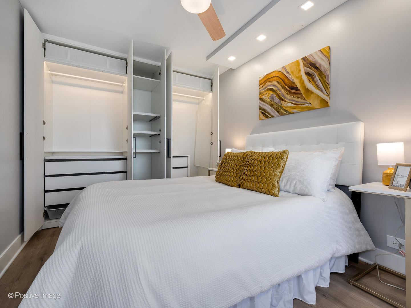 1560 North Sandburg Terrace, Unit 2403J Chicago, IL 60610 - Photo 21 of 45 a bedroom with a bed and painting on the wall