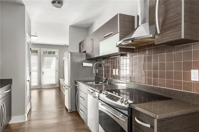 a kitchen with granite countertop a stove and a refrigerator