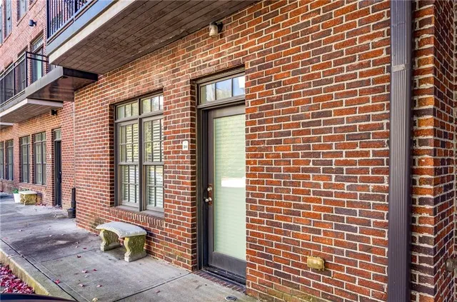 a front view of a brick house with a large windows