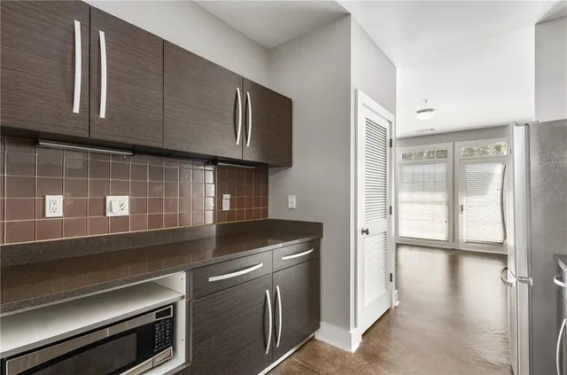 a kitchen with stainless steel appliances granite countertop a stove and a microwave