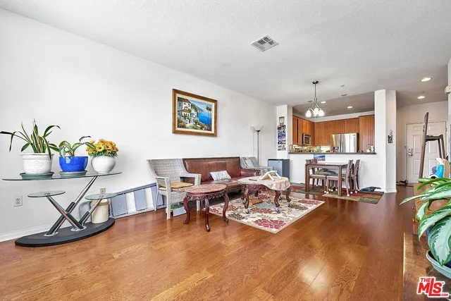 a living room with fireplace furniture and a table