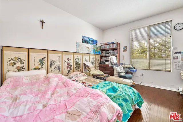 a bedroom with a bed furniture and a large window